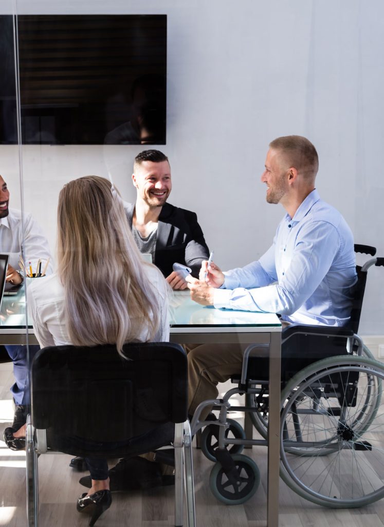 Business meeting with man in wheelchair