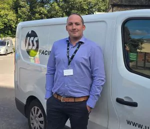 Daniel stood next to a van